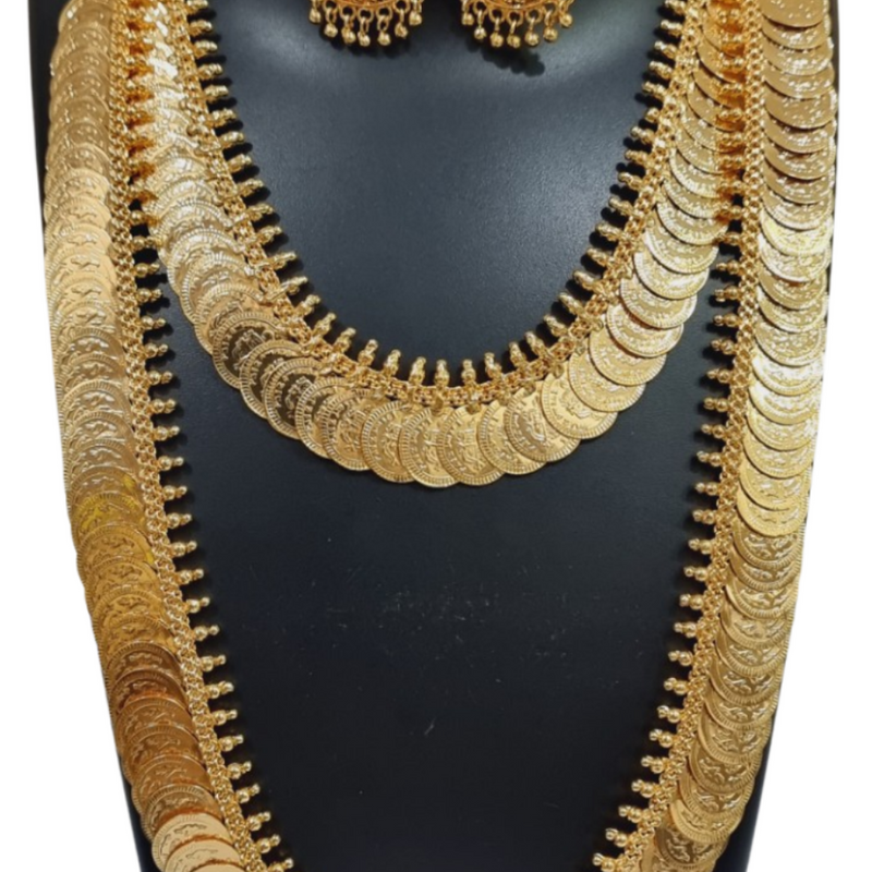 Impon Lakshmi Kasu Malai, a gold-toned jewellery set consisting of two layered coin necklaces and a pair of matching jhumka earrings on a black bust