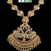 Impon Necklace, a gold-toned necklace with leaf-shaped links inset with clear and pink stones, featuring a large peacock pendant with hanging trinkets