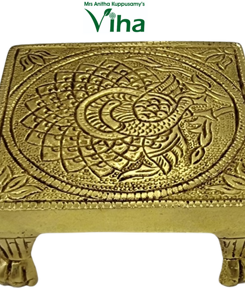 Peacock Designer Manai, a gold-toned square object featuring an embossed peacock design and standing on four carved feet