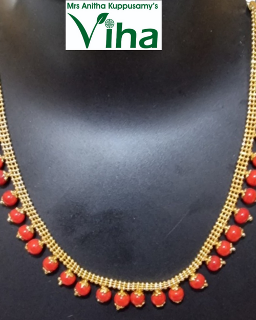 Impon Necklace, a gold-toned, mesh-like chain necklace adorned with twenty-seven hanging round red beads