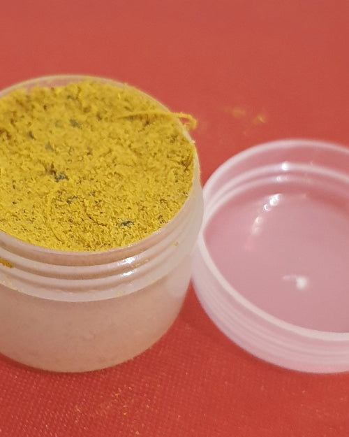 Swamy Thilagam Powder, one small round translucent jar with a yellow powder and an open lid beside it