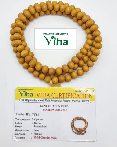 Sandal Mala, a round loop of matte tan-brown beads on a white surface with an identification card beside it