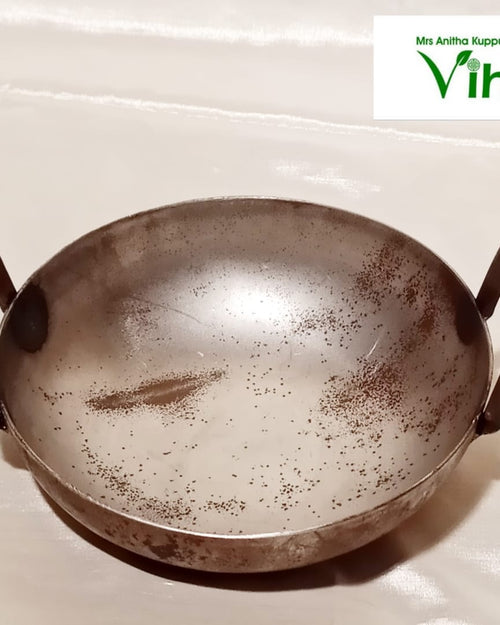 Iron Kadai, a dark metal wok with two loop handles and light rust spots