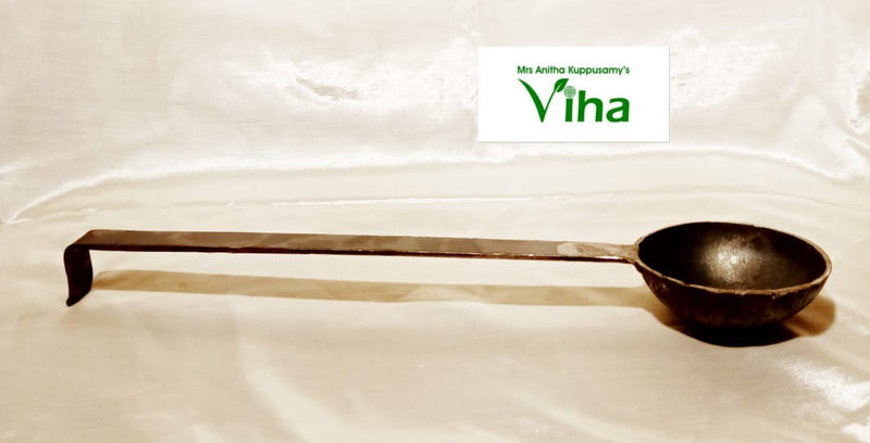 Thaalipu Karandi, a dark-grey metallic ladle with a long rectangular handle ending in a downward hook and a round bowl on the right