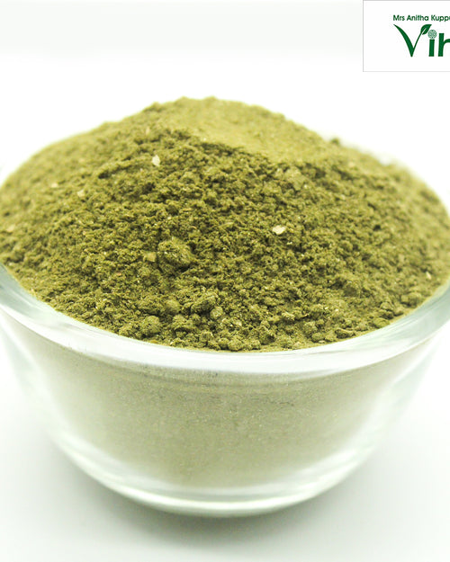 Adathodai Powder / Malabar Nut Powder, fine green powder mounded in a clear glass bowl