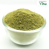 Adathodai Powder / Malabar Nut Powder, fine green powder mounded in a clear glass bowl