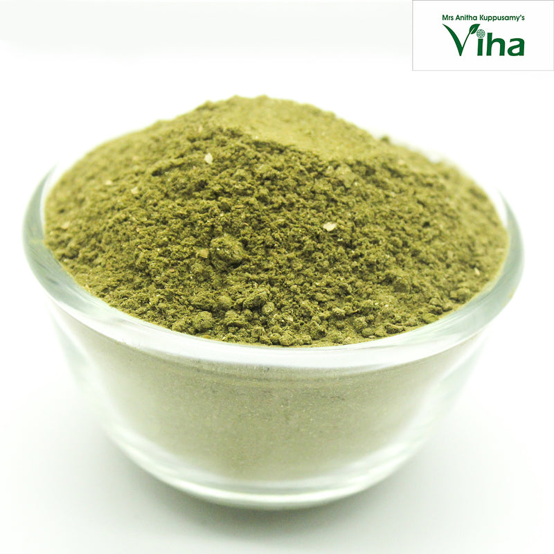Adathodai Powder / Malabar Nut Powder, fine green powder mounded in a clear glass bowl