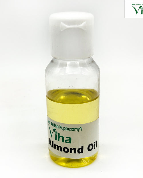 Almond Oil - Cmpressed & Organic, a small clear plastic bottle with white flip cap, filled with yellow liquid and a label near the base