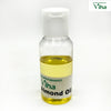 Almond Oil - Cmpressed & Organic, a small clear plastic bottle with white flip cap, filled with yellow liquid and a label near the base