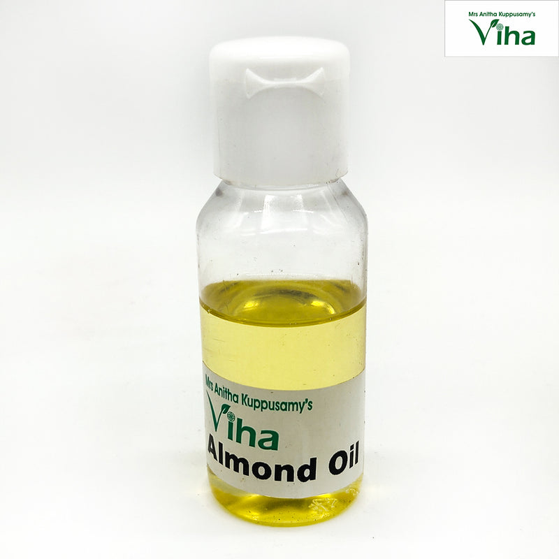 Almond Oil - Cmpressed & Organic, a small clear plastic bottle with white flip cap, filled with yellow liquid and a label near the base