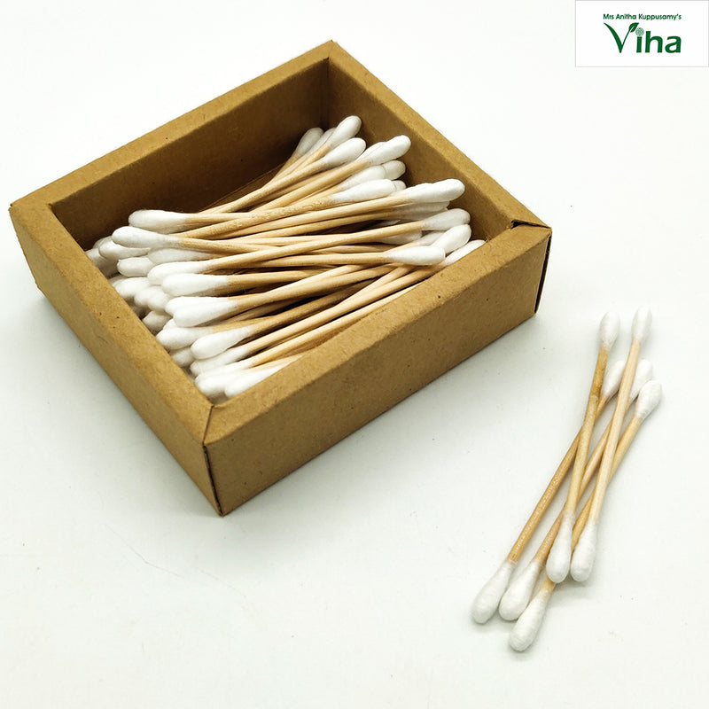 Bamboo Wood Soft Cotton Ear Buds, a rectangular brown box containing many white-tipped cotton swabs, with four loose swabs lying outside beside it