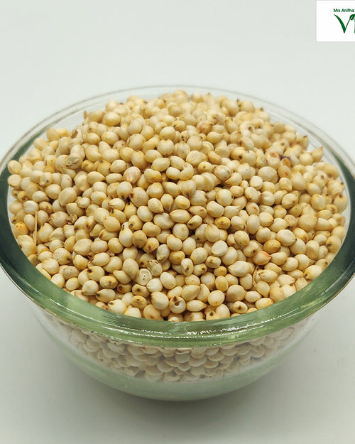 Jowar (sorghum) grains piled in a clear glass bowl