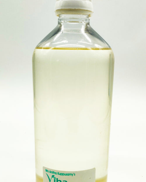 Cold Pressed Coconut Oil in a transparent plastic bottle with a white cap and pale yellow liquid