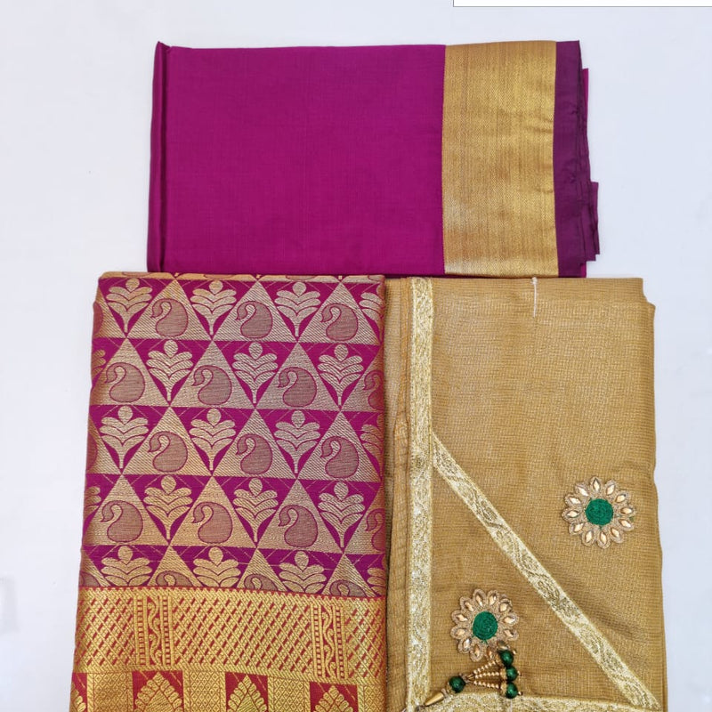 Apoorva Silk Half Saree Set, a magenta and gold-toned woven fabric set featuring two folded pieces and one flat piece with two green-centered floral appliqués