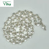 Sphatik Mala With Silver Cappings, a coiled necklace featuring numerous transparent round beads held by metallic links on white