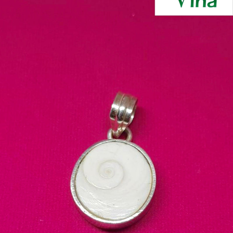 Silver Gomathi Chakra Pendant, a round silver-toned pendant with a white shell inlay showing a spiral pattern, on a magenta background