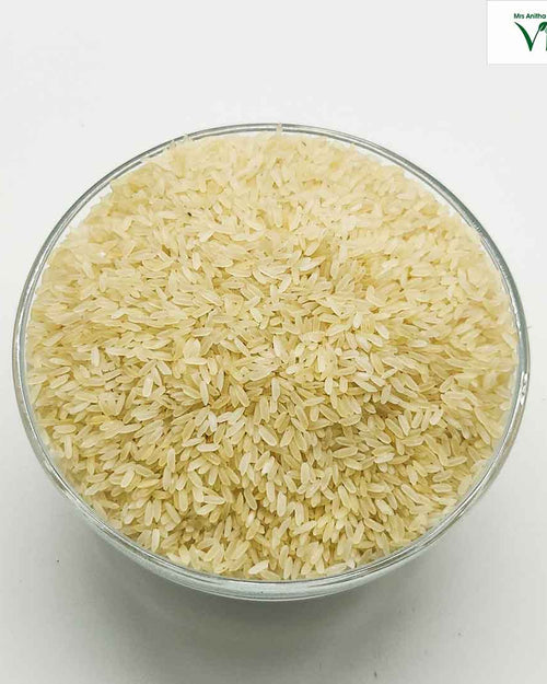 Kichili Samba Rice Kichdi Samba Rice - Organic, in a glass bowl filled with pale grains