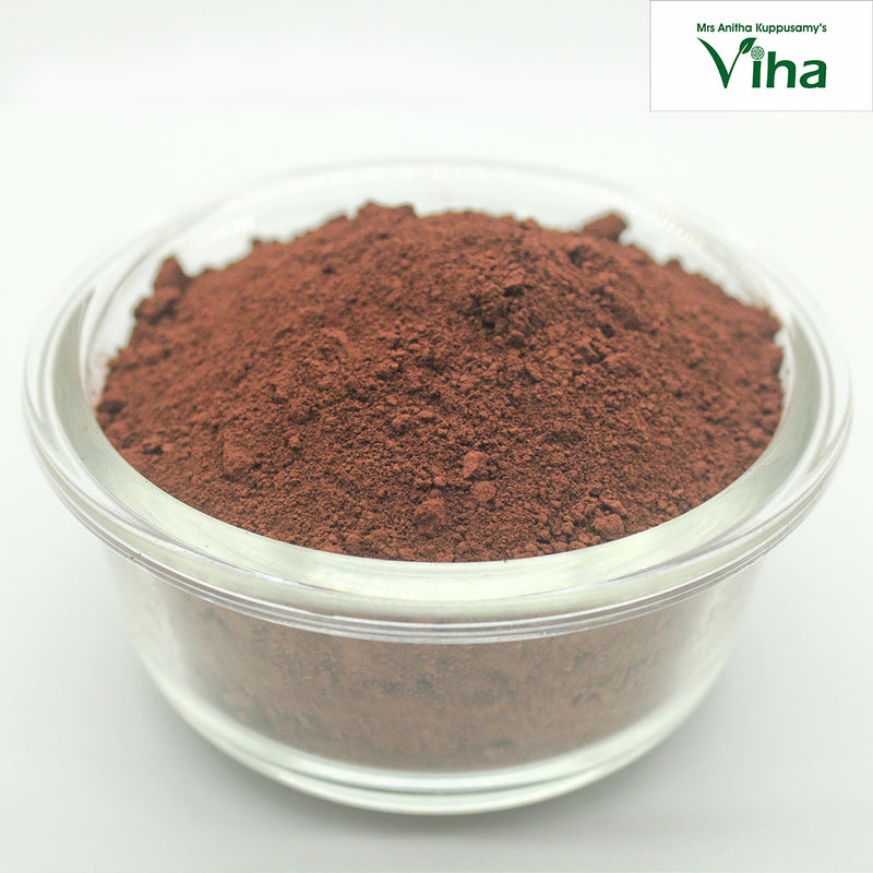 Kolam Kaavi Powder, brown powder in one clear glass bowl with a rounded rim