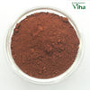 Kolam Kaavi Powder, reddish brown fine powder piled inside a round transparent glass bowl