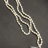 Original Pearl Mala For Men & Jap, a long strand of glossy, off-white, oblong beads with a matching white tassel at the bottom