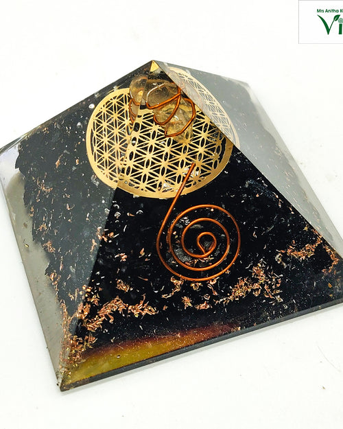 Black Tourmaline Pyramid for Vastu, pyramid with a gold flower-of-life emblem and a copper spiral wire design