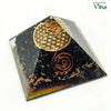 Black Tourmaline Pyramid for Vastu, pyramid with a gold flower-of-life emblem and a copper spiral wire design