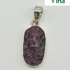 Ruby Ganesha Silver Pendant, one oval metallic-framed pendant holding one carved dark red stone featuring an elephant-headed figure