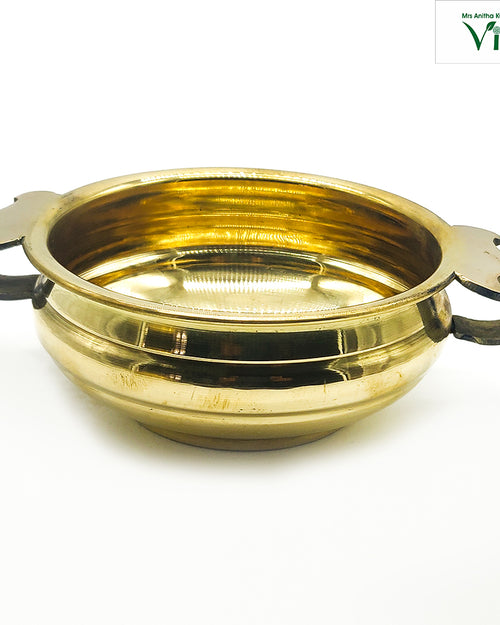 Vastu Uruli (urli), brass shallow bowl with two decorative handles attached to opposite sides of the rim