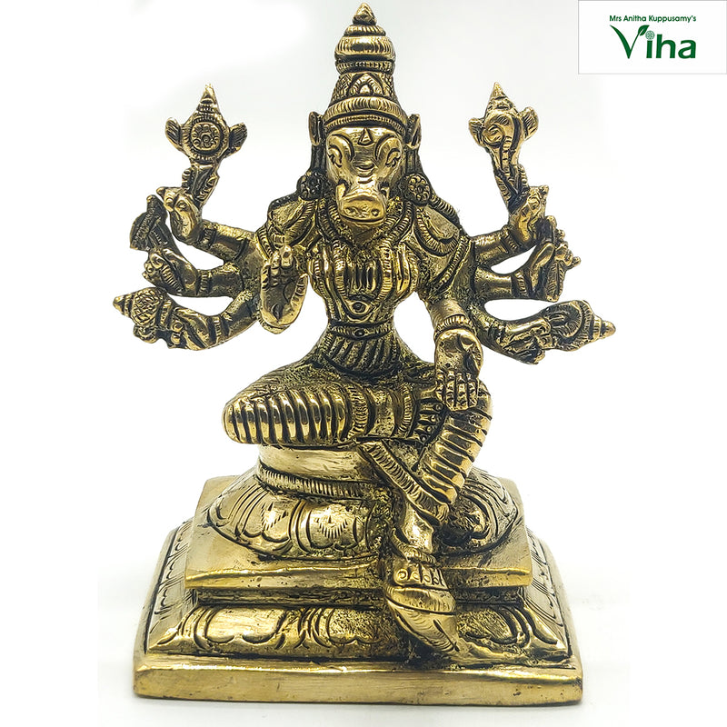 Varahi Amman in brass, boar-headed multi-armed figure seated cross-legged on a stepped square base with a tall crown