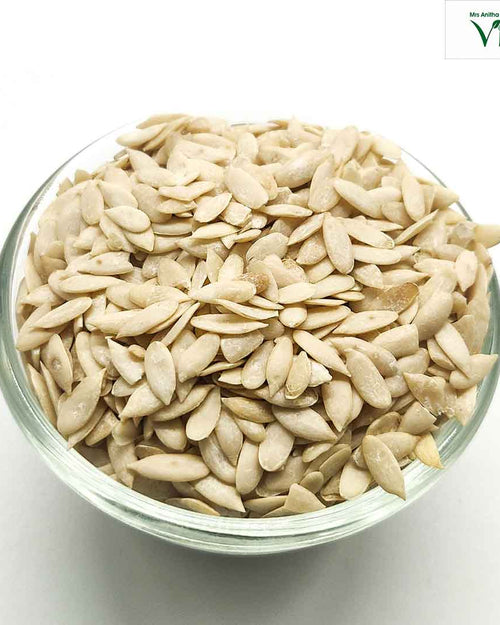 Skin Removed Cucumber Seeds Edible, a transparent glass bowl filled with beige-colored, flat, oval-shaped seeds with smooth matte surfaces