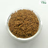 Veppam Poo, a clear round bowl filled with brown dried flower fragments and tiny twigs viewed from above against a white background