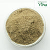 Vettiver Powder, a bowl filled with a mound of fine brownish-grey powder