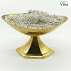 Cow Dung Vibhooti, a gold-toned footed bowl holding off-white powder
