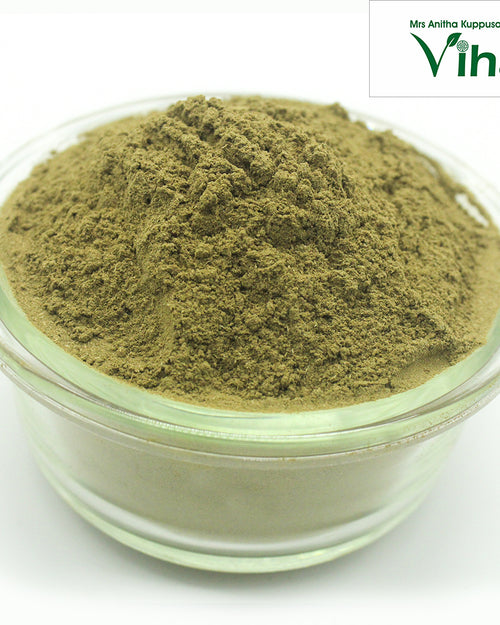 Vilvam Powder / Bael Powder, a clear glass round bowl containing a mounded pile of fine, olive-green powder