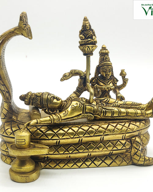 Shivan Perumal in brass, reclining figure on a serpent couch beneath a raised multi-hooded cobra